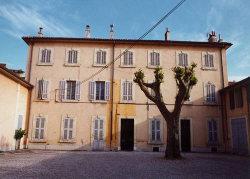 Building with a tree in front of it